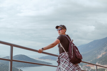 Fototapeta premium Eco-conscious solo traveler exploring rural landscapes, embracing nature, mindfulness, and sustainability. Concept of green tourism, digital detox, and slow travel for self-discovery and harmony.