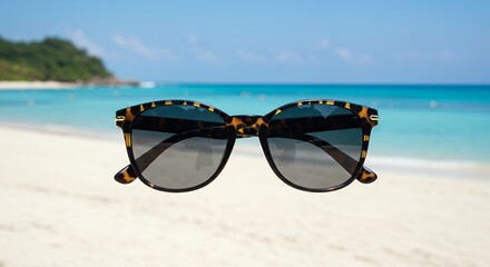 Stylish sunglasses on beach background