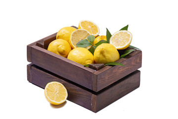 Fresh and ripe lemons on wooden box isolated on white