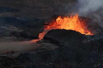 Hot, Glowing Lava Flowing from a Volcano Crater. Volcanic Eruption in Iceland.