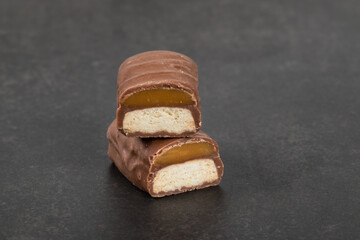 Mini Chocolate bar with caramel and cookie. Dark background. 