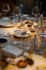 Champagne tasting, Wine glasses are on the table, stylish table setting, sparkling wine bubbles, oysters and sea urchins, special sauce