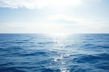Obraz premium Serene ocean scene, sun glistening on tranquil waters under a bright sky