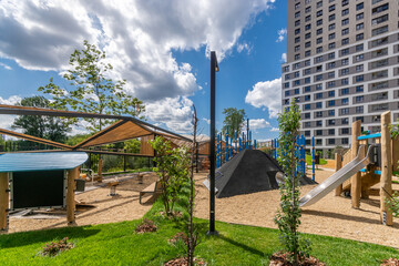 Playground oasis offers children a fun and safe space for outdoor activities amidst modern urban architecture
