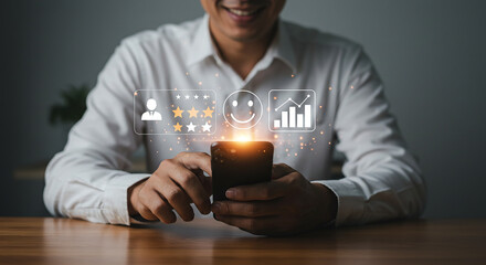 Man using smartphone with customer feedback icons floating above the screen on a wooden table top selling, purchasing, agreement, $