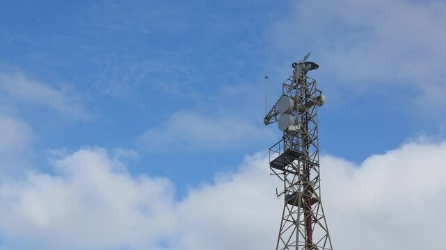 Tall SIVE radar tower rising, supporting multiple antennas and satellite dishes used for maritime border control