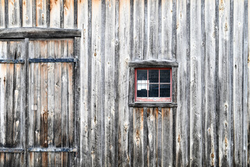 Old weathered wood barn wall, door and window