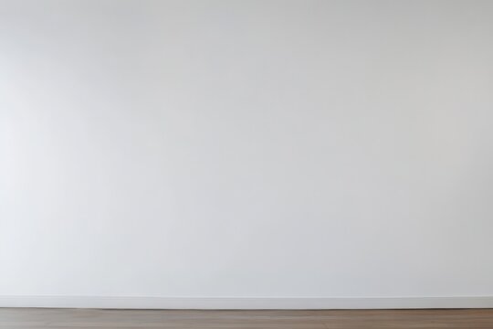 Blank, white wall meets a light brown wooden floor.  A simple, empty interior space, perfect for showcasing decor