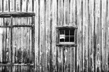 Old weathered wood barn wall, door and window