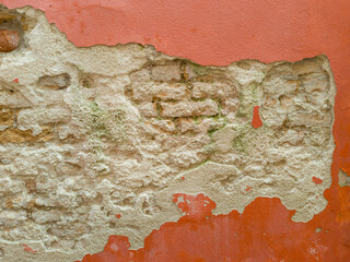 Cracked Plaster Wall with Exposed Brick