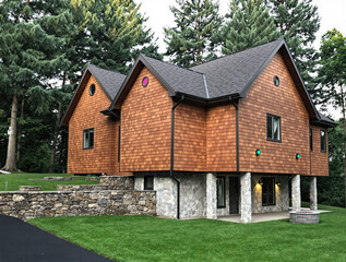 Obraz premium contemporary elevated house with cedar wood siding and stone accents