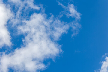 Obraz premium White cumulus clouds are creating a beautiful scene in the vast blue sky