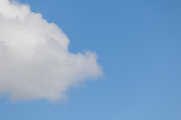 Fototapeta premium White cumulus clouds are creating a beautiful scene in the vast blue sky