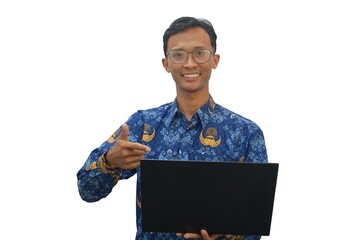 An Asian man wearing an Indonesian civil servant uniform holding a laptop showing a happy expression