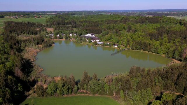 Aerial view of Esssee, a shrinking glacial lake near the Max Planck Institute for Biological Intelligence, in Seewiesen, Gemeinde Poecking, Landkreis Starnberg, Upper Bavaria, Germany in spring