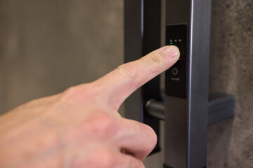 A Close Up of a Finger Utilizing the Latest Modern Smart Lock Technology for Security and Access