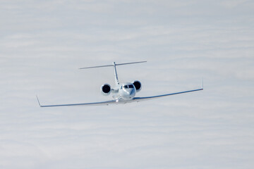 Frontal view of a Gulfstream IV (business jet) over  cloud layers