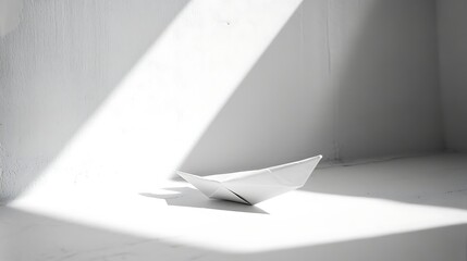 Simple origami boat illuminated by sunlight.