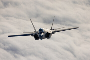 Very  close frontal view of a F-35C Lightning II   over clouds