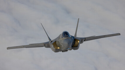 Very  close frontal view of a F-35C Lightning II   over clouds