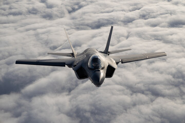Very  close top view of a F-35C Lightning II   over clouds