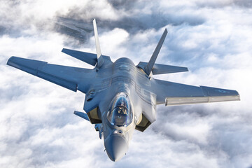Very  close top view of a pair of F-35C Lightning II   over clouds in beautiful light
