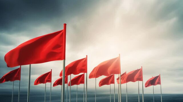 Vibrant Red Flags Against Dramatic Sky in Scenic Coastal Landscape