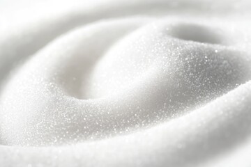 Close-up of a pile of white sugar with a bright and shimmering texture, creating a soft, blurred background.