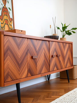 Retro mid-century wood furniture  . Stylish wooden sideboard with herringbone pattern and black legs.