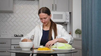 Woman preparing salad, chopping vegetables, cutting Chinese cabbage on a wooden board in her kitchen, highlighting culinary skill. vertical video - Powered by Adobe