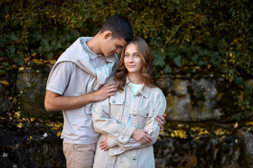 Fototapeta premium Embracing Teen Love in the Greenery of the Park.