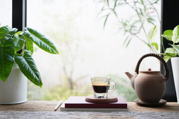 Coffee glass cup and plant pot, cozy indoor workspace 