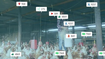 Male farmer pouring feed to chickens from bucket on poultry farm, with floating social media icons - Powered by Adobe