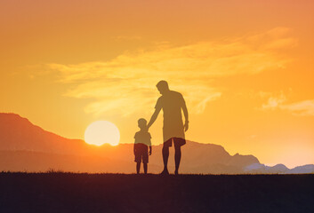 Fototapeta premium Father don walking into the sunset, parent child family relationship bonding 