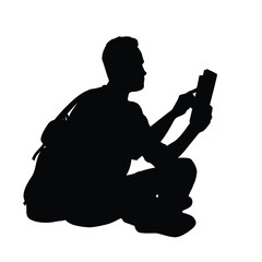 Silhouette of a man reading book