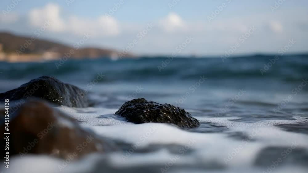 Aufkleber close-up of ocean waves crashing on rocks with white foam blue water and sky creating a tranquil sce
