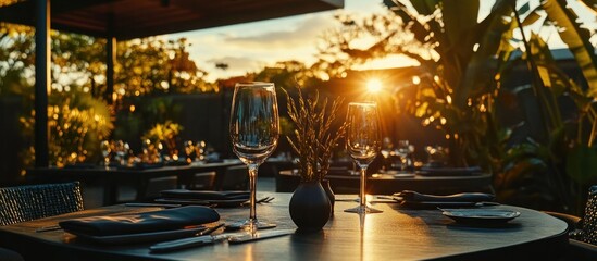 sunset dining atmosphere with sophisticated table setting and lush foliage, creating a warm and inviting ambiance, ideal for upscale restaurant