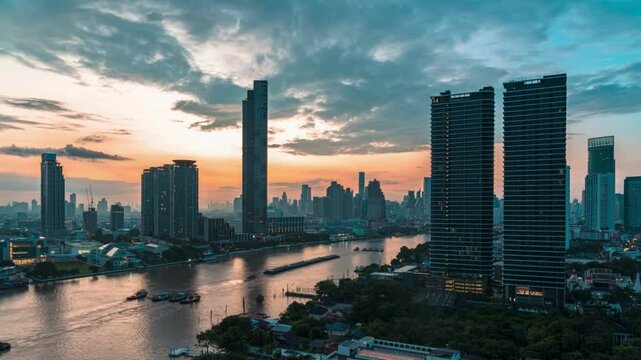 4K Time lapse of Bangkok cityscape river side with Chao praya river at the sunrise time with the day to night concept
