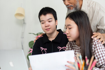 Family Bonding and Learning. A girl with Down syndrome shares a learning moment with her family.