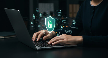 Cybersecurity interface displayed over hands typing on a laptop. Shield icon representing safety and security is highlighted.