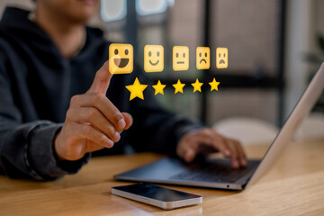 customer service evaluation and feedback rating. costumer review concept, man using phone chooses happy smiling face