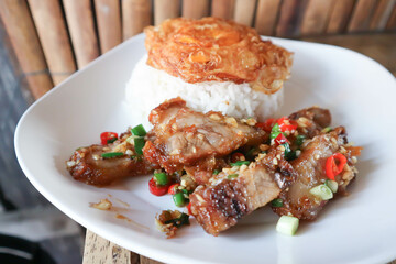 stir fried pork or deep fried pork , fried pork or crispy pork and rice with fried egg or sunny side up egg or pork and rice