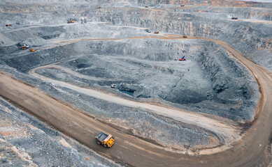Panoramic of open pit mine industry, aerial view. Big yellow mining truck for coal working in quarry
