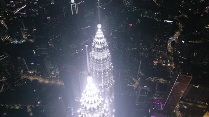 kuala lumpur, malaysia - april 30, 2025 : Urban landscape at night, with the illuminated towers standing tall.