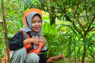Young Asian woman farmer checking industrial scale durian plantation © Ayudia
