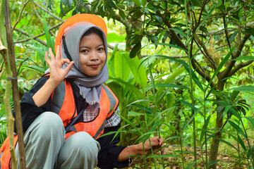 Young Asian woman farmer checking industrial scale durian plantation © Ayudia