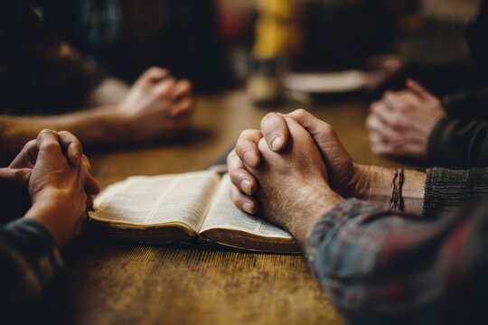 Group praying together with open bible in center focus hope and faith sharing christian values spirituality and community support