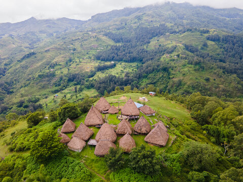 Aerial view of a complex of traditional houses in one of the villages in the Aileu Municipality in Timor Leste located in a hilly area. Still actively inhabited by locals and a tourist attraction.