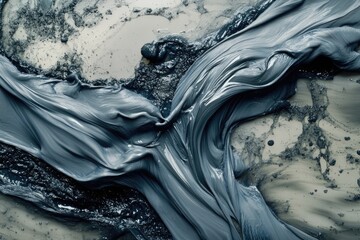 Dark gray substance flowing over a surface