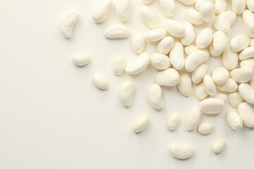 Scattered white beans against pure white backdrop, kidney, isolated, still life